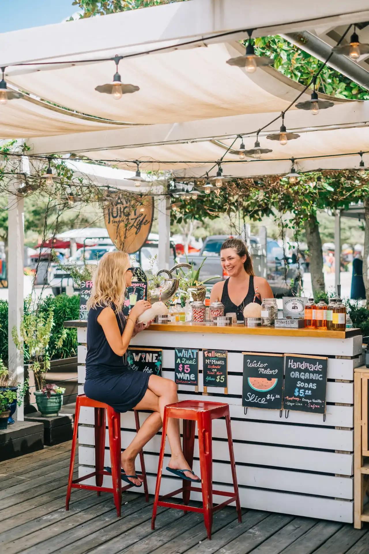 Picture of a girl sitting on the food counter and speaking with the girl.